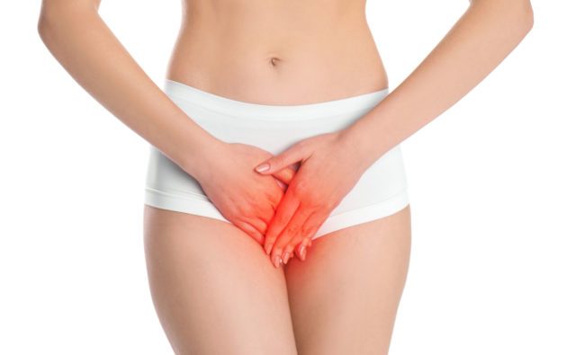 Woman suffering from vaginal yeast infection on white background